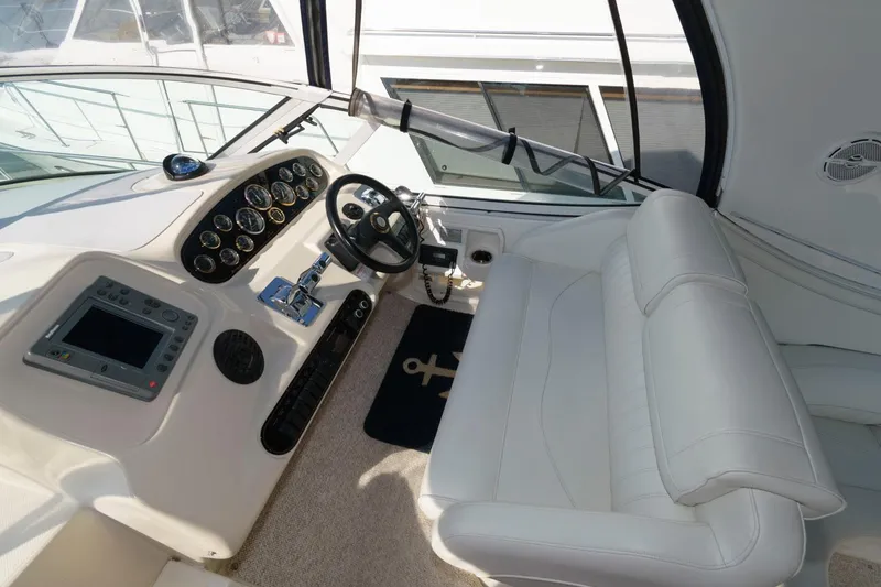 Slide: The Image of Cockpit of 2000 Cruisers Yachts 3672 Express with white leather seating and modern controls. - 8
