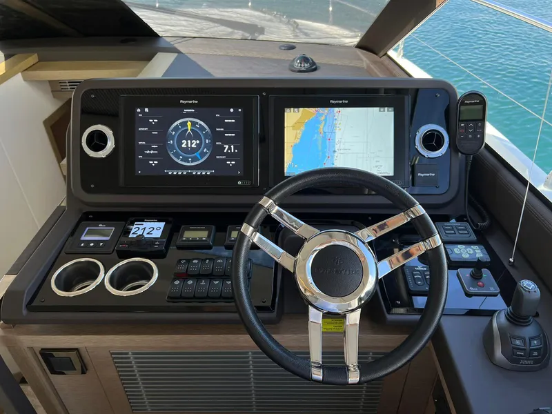Slide: The Image of Prestige 520 S 2020 yacht helm station with navigation screens and controls. - 13