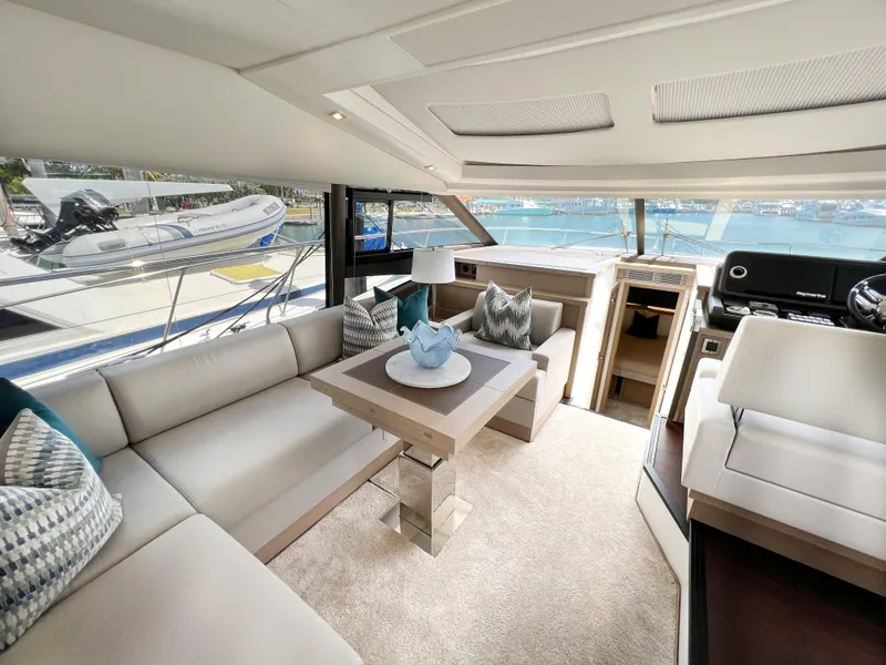 Slide: The Image of Luxurious interior of 2020 Prestige 520 S yacht with modern seating and scenic views. - 16