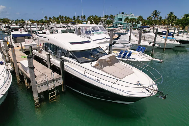 Slide: The Image of 2020 Prestige 520 S yacht docked at a marina with other boats. - 4