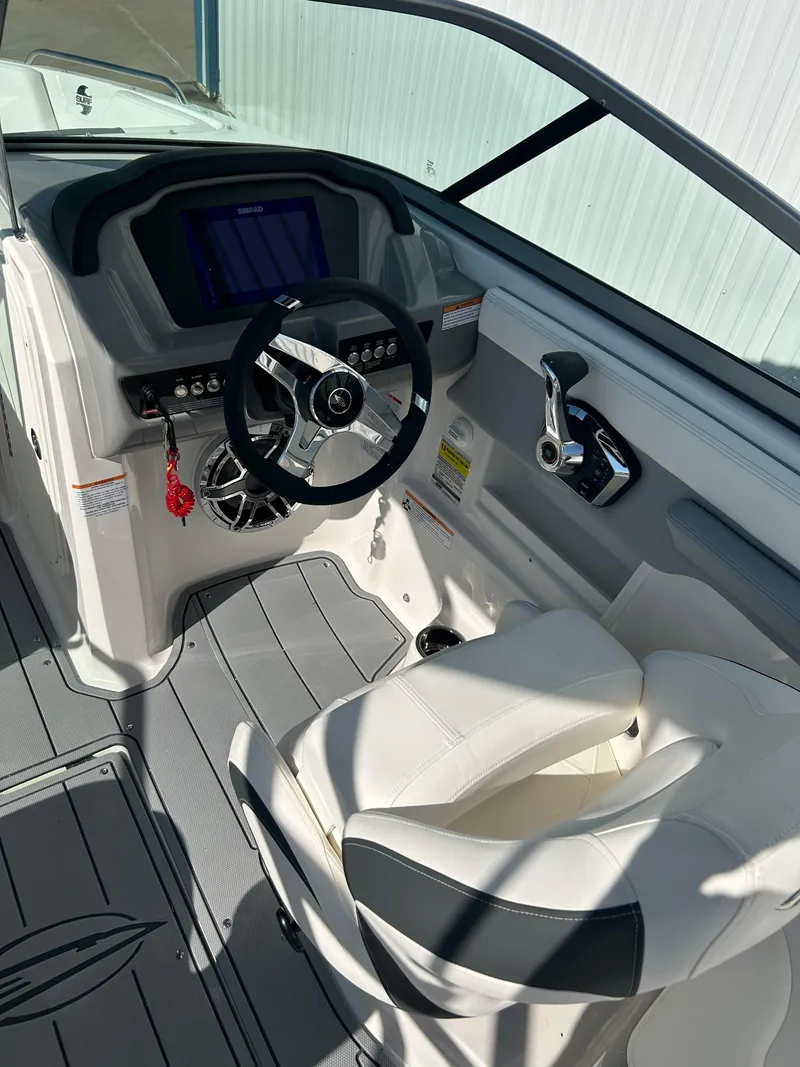 Slide: The Image of 2024 Chaparral 23 Surf boat cockpit with steering wheel and control panel. - 5