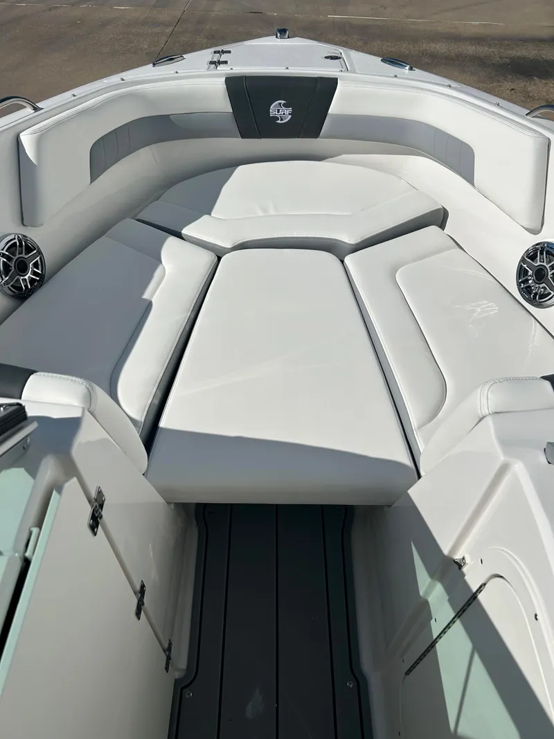 Slide: The Image of 2024 Chaparral 23 Surf boat interior with cushioned seating and speakers. - 7