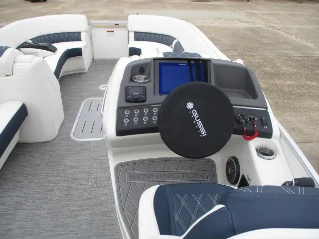 Slide: The Image of 2023 Bennington 25QFBA boat interior with steering console and seating. - 10