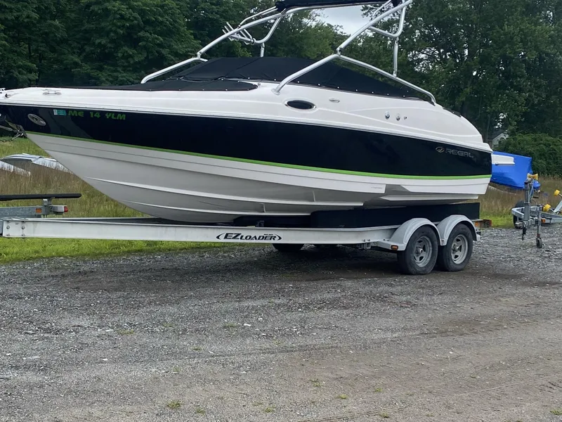 Slide: The Image of 2008 Regal 2400 BR boat on EZ Loader trailer in outdoor setting. - 0