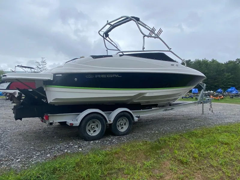 Slide: The Image of 2008 Regal 2400 BR boat on a trailer in a gravel lot. - 1