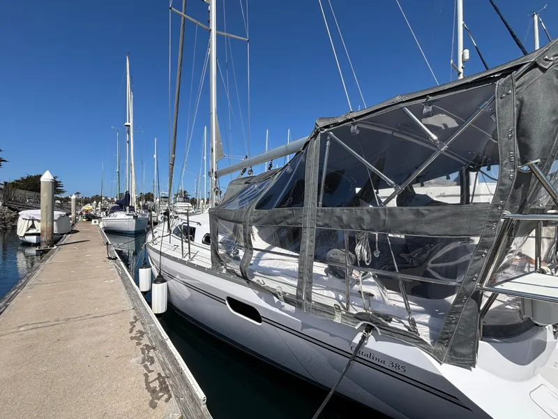 Slide: The Image of 2019 Catalina 385 sailboat docked at marina under clear blue sky. - 1
