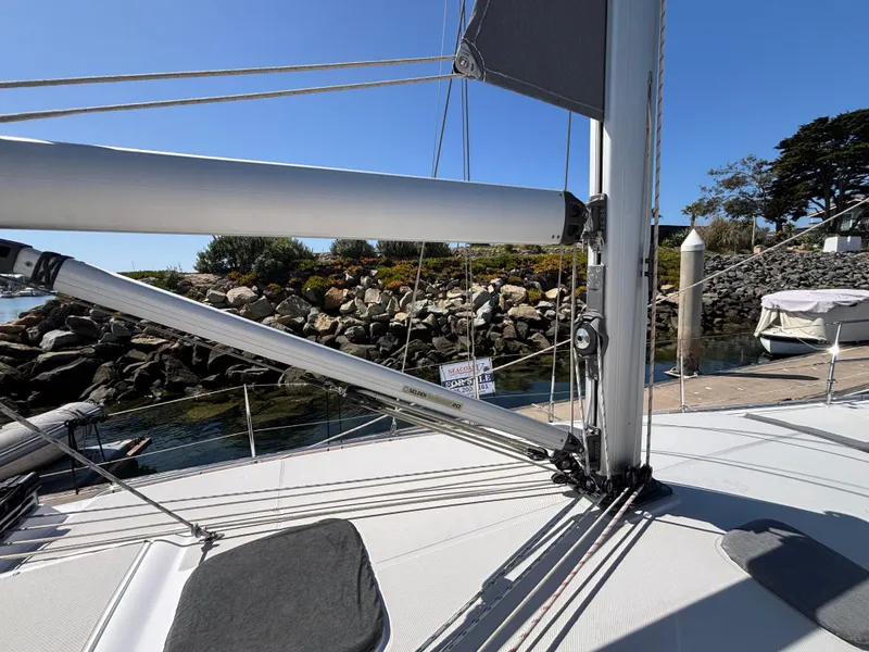 Slide: The Image of Sailboat deck view of 2019 Catalina 385, docked near rocky shoreline. - 10