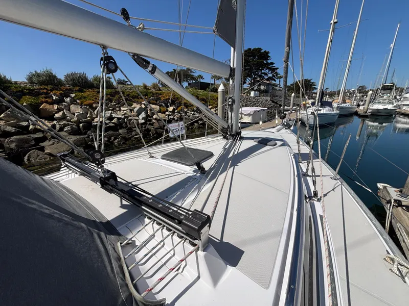 Slide: The Image of 2019 Catalina 385 sailboat deck view in marina, showcasing rigging and sleek design. - 11