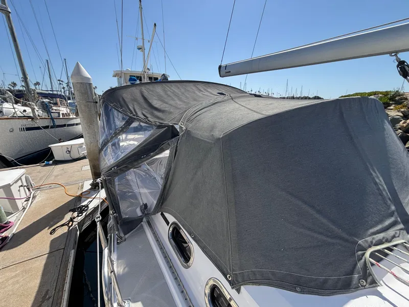 Slide: The Image of Sailboat Catalina 385 (2019) docked with protective cover, sunny marina setting. - 13