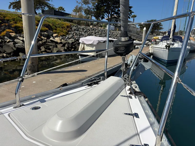 Slide: The Image of 2019 Catalina 385 sailboat docked, showcasing deck and railing details. - 15