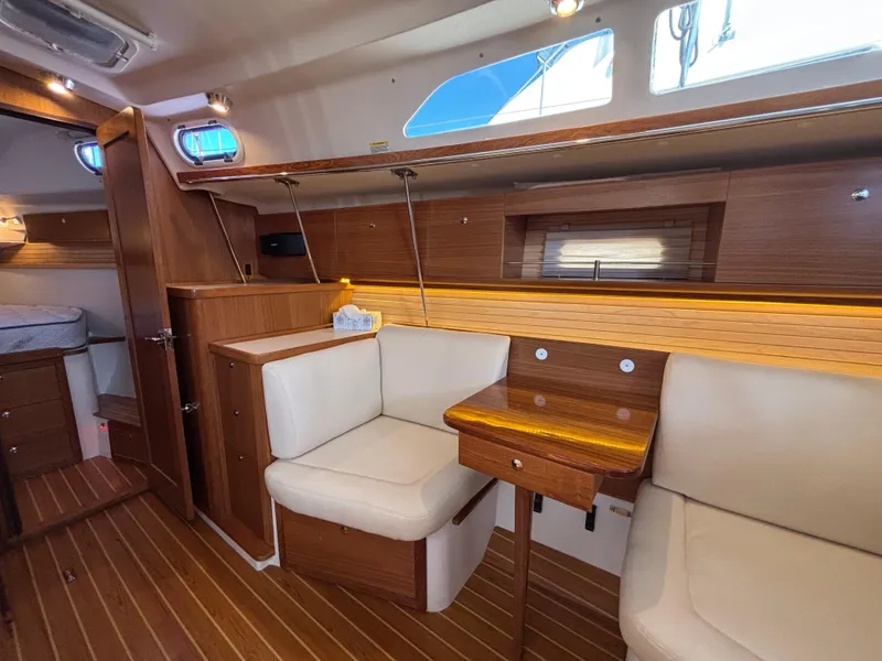 Slide: The Image of Interior of 2019 Catalina 385 sailboat with wooden furnishings and cozy seating area. - 21