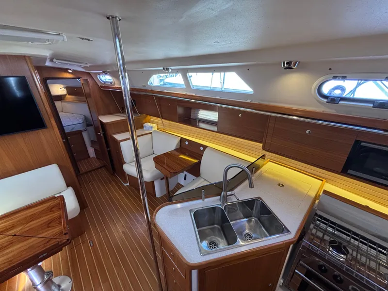 Slide: The Image of Interior of 2019 Catalina 385 sailboat with modern kitchen and seating area. - 24