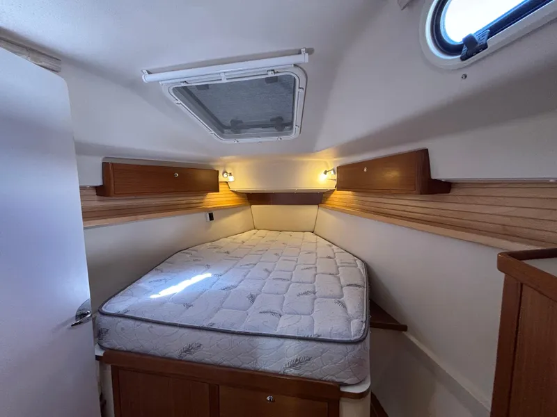Slide: The Image of Cozy cabin interior of 2019 Catalina 385 sailboat with bed and wooden accents. - 29
