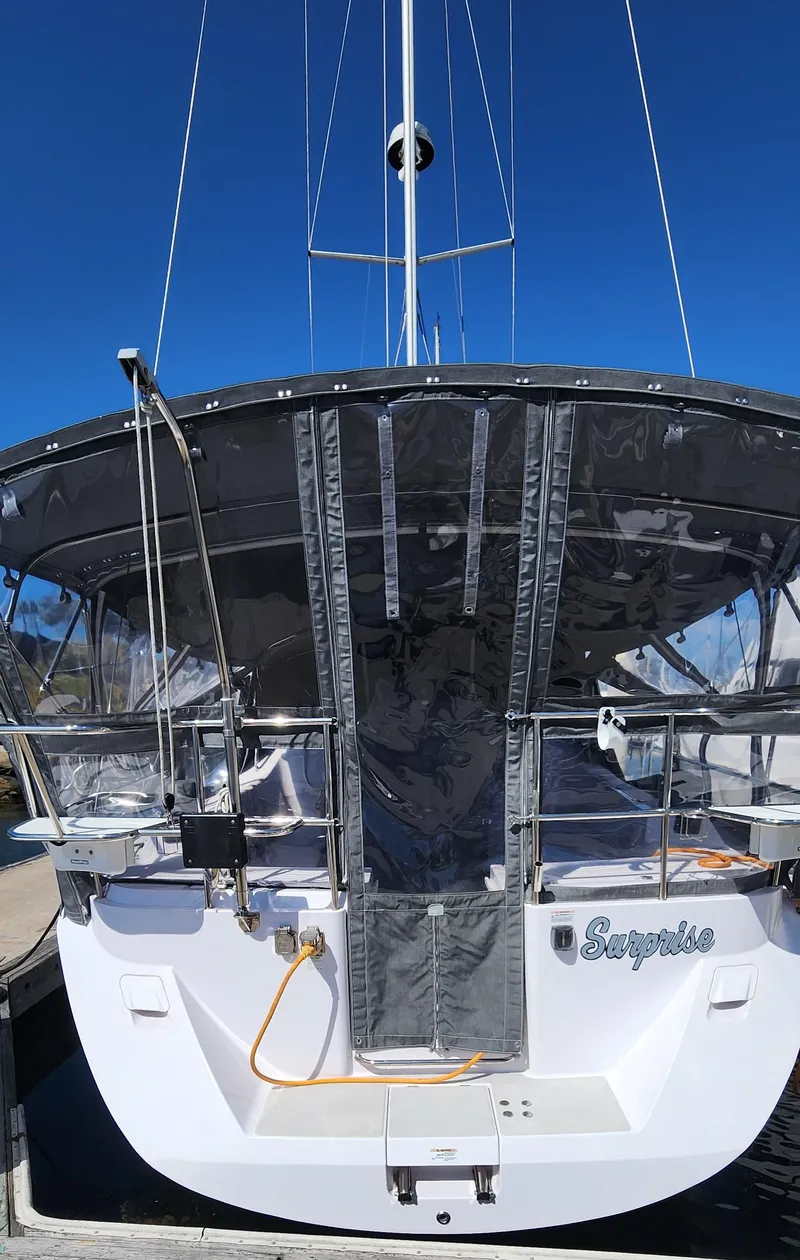 Slide: The Image of 2019 Catalina 385 sailboat docked, rear view with canopy and clear skies. - 32