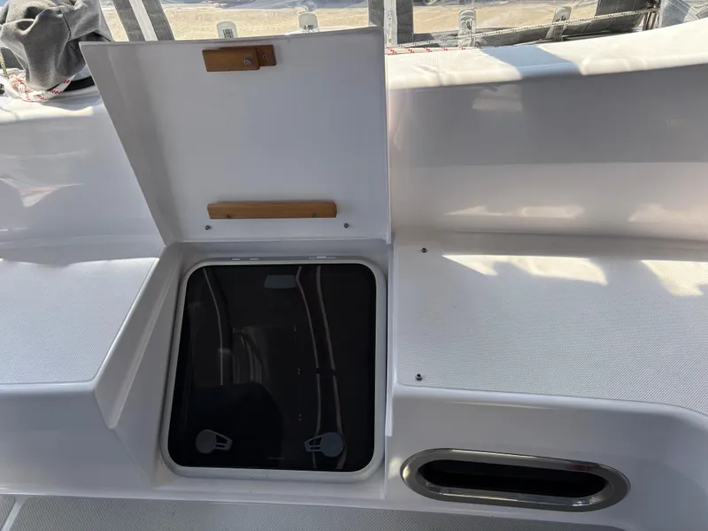 Slide: The Image of Open hatch on 2019 Catalina 385 sailboat deck, showing storage compartment. - 7