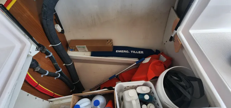 Slide: The Image of Storage compartment in a 2019 Catalina 385 sailboat with emergency tiller and supplies. - 8