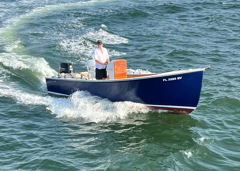 Slide: The Image of 1999 Northern Bay Center Console boat cruising on the water. - 2