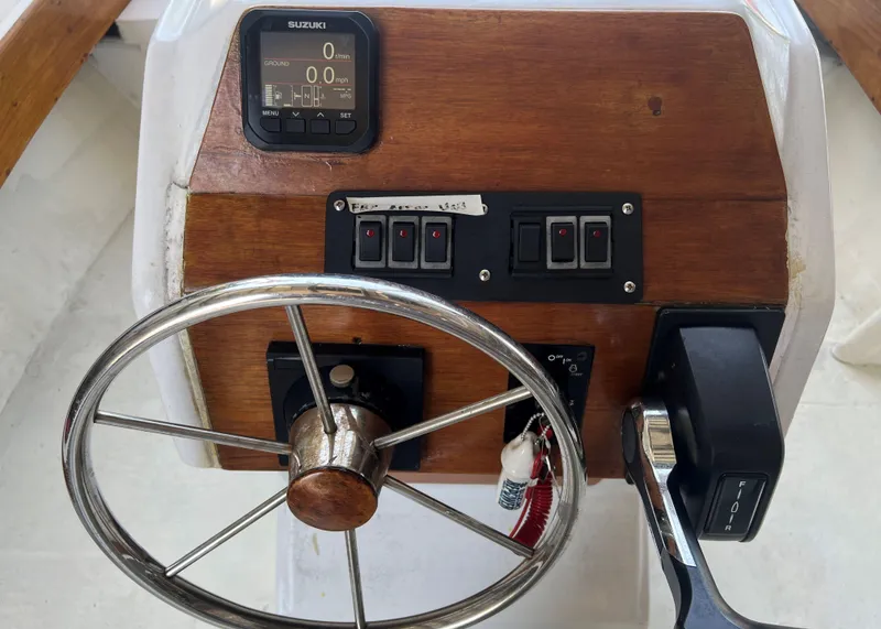 Slide: The Image of 1999 Northern Bay Center Console boat steering wheel and control panel. - 3