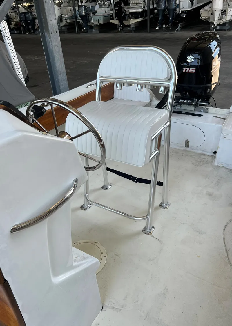 Slide: The Image of 1999 Northern Bay Center Console boat interior with steering wheel and seating. - 4