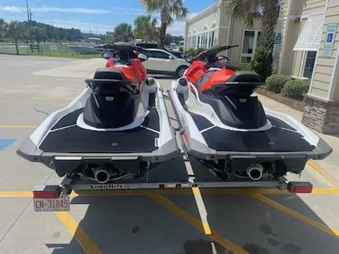 Slide: The Image of 2021 Yamaha WaveRunner VX Cruiser jet skis on a trailer in a parking lot. - 2