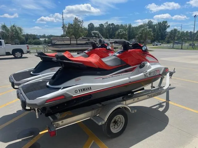 Slide: The Image of 2021 Yamaha WaveRunner VX Cruiser jet skis on a trailer in a parking lot. - 3