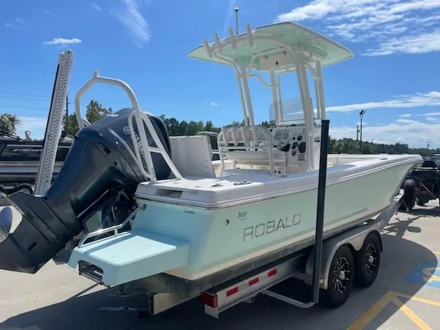 Slide: The Image of 2016 Robalo 246 Cayman boat on a trailer, rear view, sunny day. - 5