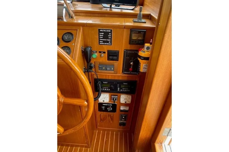 Slide: The Image of Control panel of 2002 Grand Banks 46 Classic yacht with wooden steering wheel. - 11