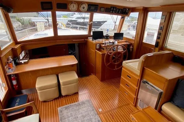 Slide: The Image of Interior of 2002 Grand Banks 46 Classic yacht with wooden helm and seating area. - 12