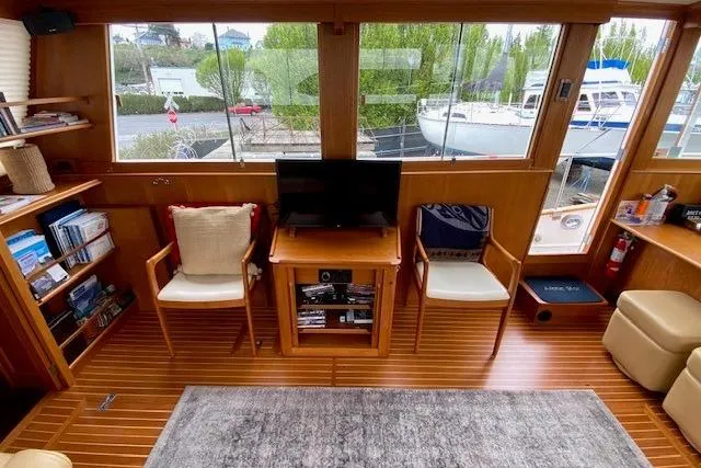 Slide: The Image of Interior of 2002 Grand Banks 46 Classic yacht with wooden flooring and cozy seating. - 13