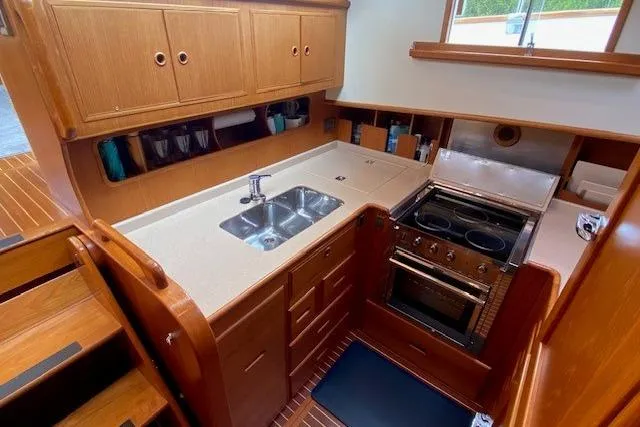 Slide: The Image of Galley kitchen in 2002 Grand Banks 46 Classic yacht with wood cabinetry and modern appliances. - 18