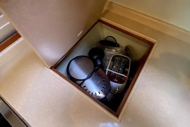 Slide: The Image of Storage compartment on 2002 Grand Banks 46 Classic yacht with kitchen appliances. - 21