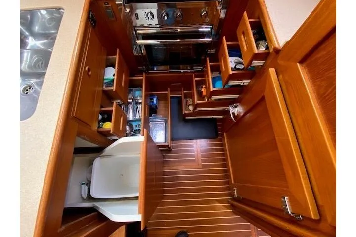 Slide: The Image of Galley of 2002 Grand Banks 46 Classic yacht with wooden cabinetry and ample storage. - 22