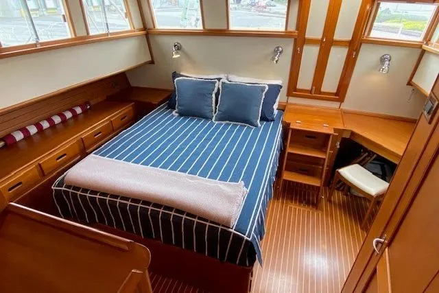 Slide: The Image of Luxurious cabin interior of 2002 Grand Banks 46 Classic yacht with striped bedding. - 24
