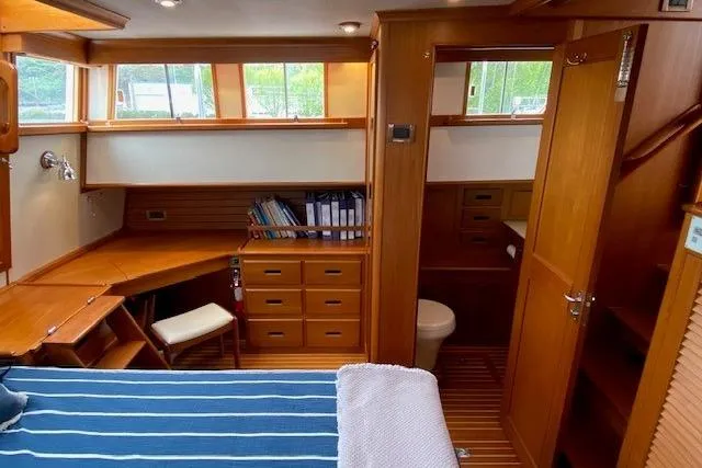 Slide: The Image of 2002 Grand Banks 46 Classic yacht interior with wooden cabinetry and cozy workspace. - 26
