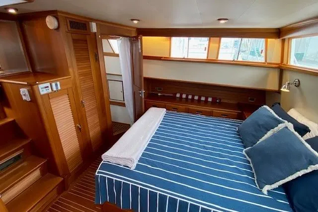 Slide: The Image of Luxurious cabin interior of 2002 Grand Banks 46 Classic yacht with striped bedding. - 27