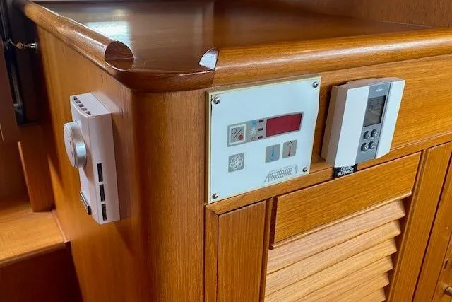 Slide: The Image of Control panel on 2002 Grand Banks 46 Classic yacht with wooden cabinetry. - 28