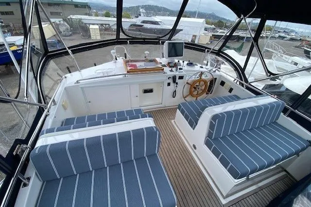 Slide: The Image of Flybridge of 2002 Grand Banks 46 Classic yacht with striped seating and navigation equipment. - 3