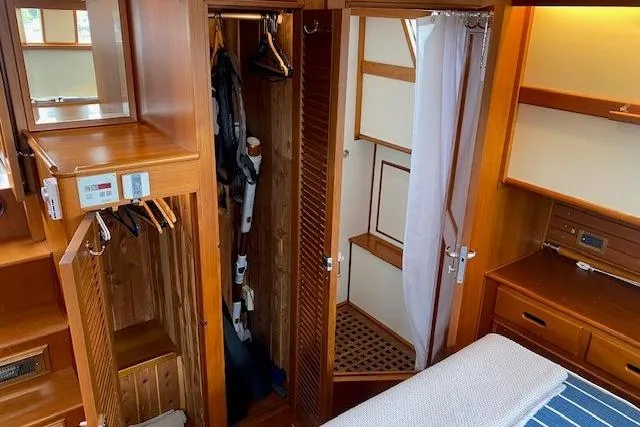 Slide: The Image of Luxurious 2002 Grand Banks 46 Classic yacht interior with wooden cabinetry and cozy bedroom. - 30