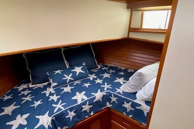 Slide: The Image of Cozy cabin bedroom in 2002 Grand Banks 46 Classic with starfish-themed bedding. - 33