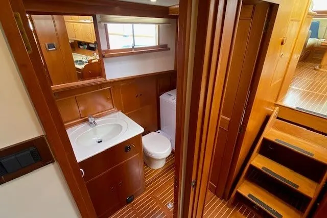 Slide: The Image of Luxurious 2002 Grand Banks 46 Classic yacht bathroom with wooden cabinetry and modern fixtures. - 36