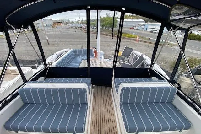 Slide: The Image of 2002 Grand Banks 46 Classic yacht with striped seating and spacious deck area. - 4