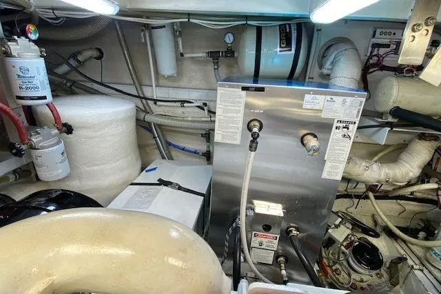 Slide: The Image of Engine room of 2002 Grand Banks 46 Classic yacht, featuring mechanical equipment and piping. - 44