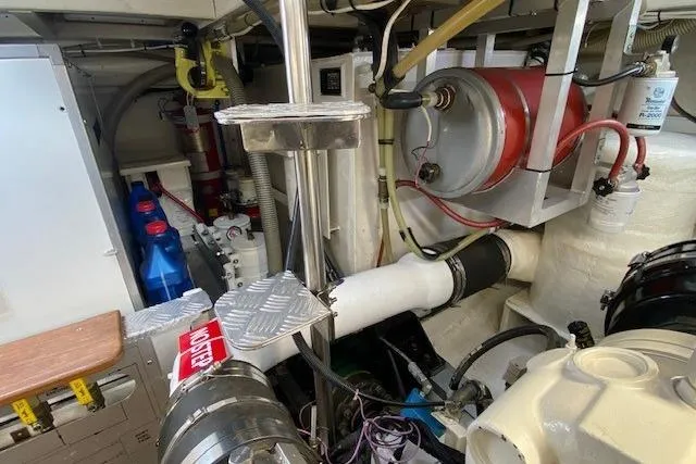 Slide: The Image of Engine room of 2002 Grand Banks 46 Classic yacht, showcasing mechanical components and equipment. - 46
