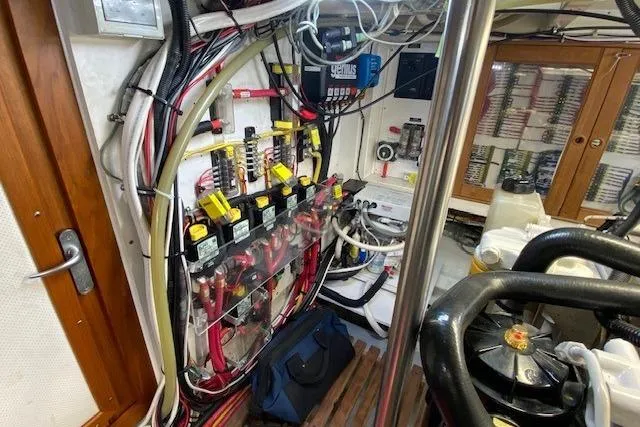 Slide: The Image of Electrical system inside a 2002 Grand Banks 46 Classic yacht, showcasing wiring and components. - 49