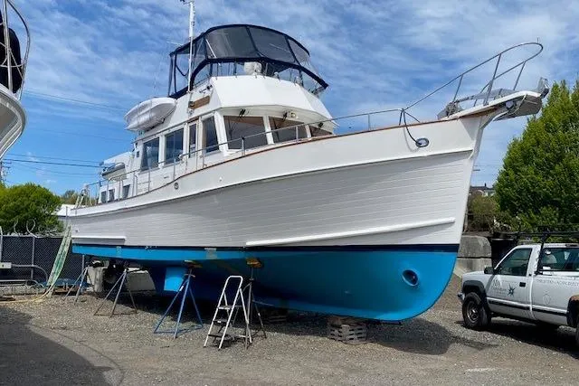 Slide: The Image of 2002 Grand Banks 46 Classic yacht on dry dock with blue hull and white superstructure. - 53