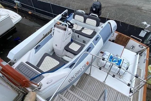 Slide: The Image of Grand Banks 46 Classic 2002 yacht with inflatable tender on deck, docked at marina. - 6