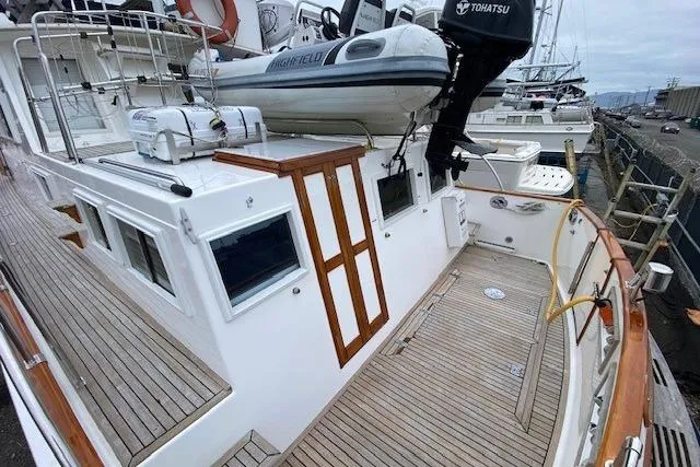 Slide: The Image of Grand Banks 46 Classic 2002 yacht with wooden deck and inflatable boat on top. - 7
