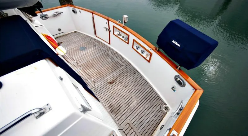 Slide: The Image of Grand Banks 46 Classic 2002, teak deck and railing, overlooking water. - 8