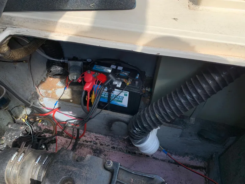 Slide: The Image of 1987 Sea Ray 268 Sundancer engine compartment with battery and wiring. - 14