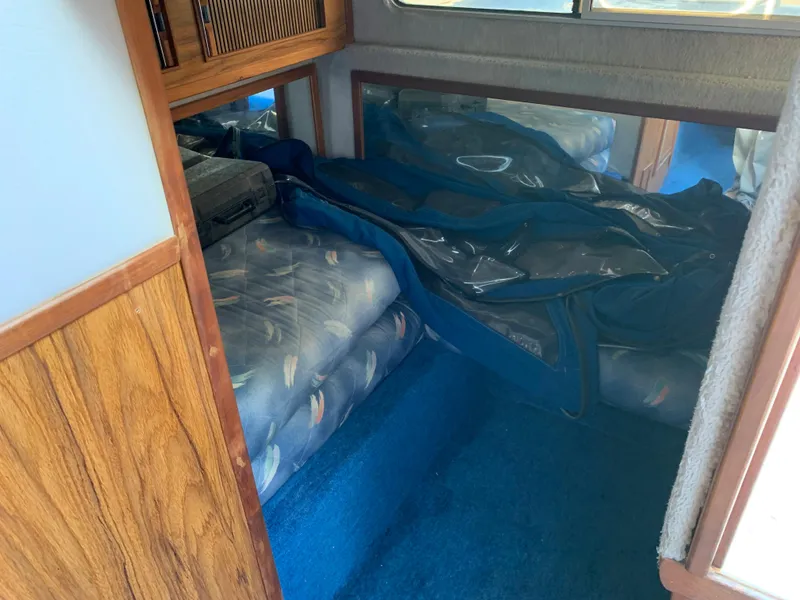 Slide: The Image of Interior cabin of 1987 Sea Ray 268 Sundancer with blue carpet and wooden accents. - 5